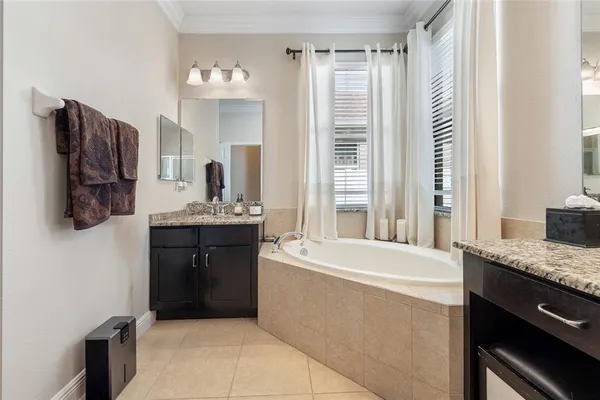 a bathroom with a bathtub sink and mirror