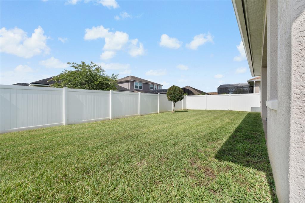4436 Azure Isle Way Kissimmee, FL 34744 - Photo 27 of 35 a view of an house with backyard space and garden