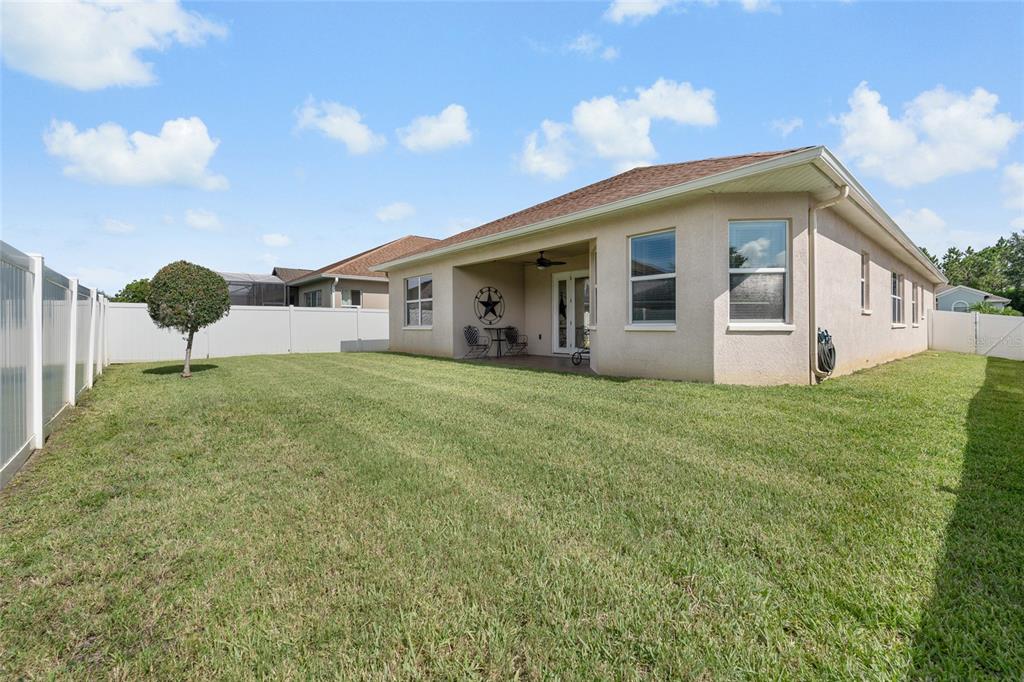 4436 Azure Isle Way Kissimmee, FL 34744 - Photo 28 of 35 a front view of house with yard and green space