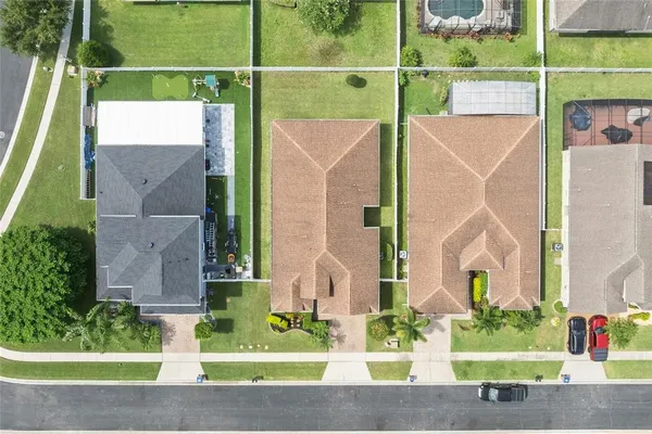 a view of a house with a small yard and a large tree