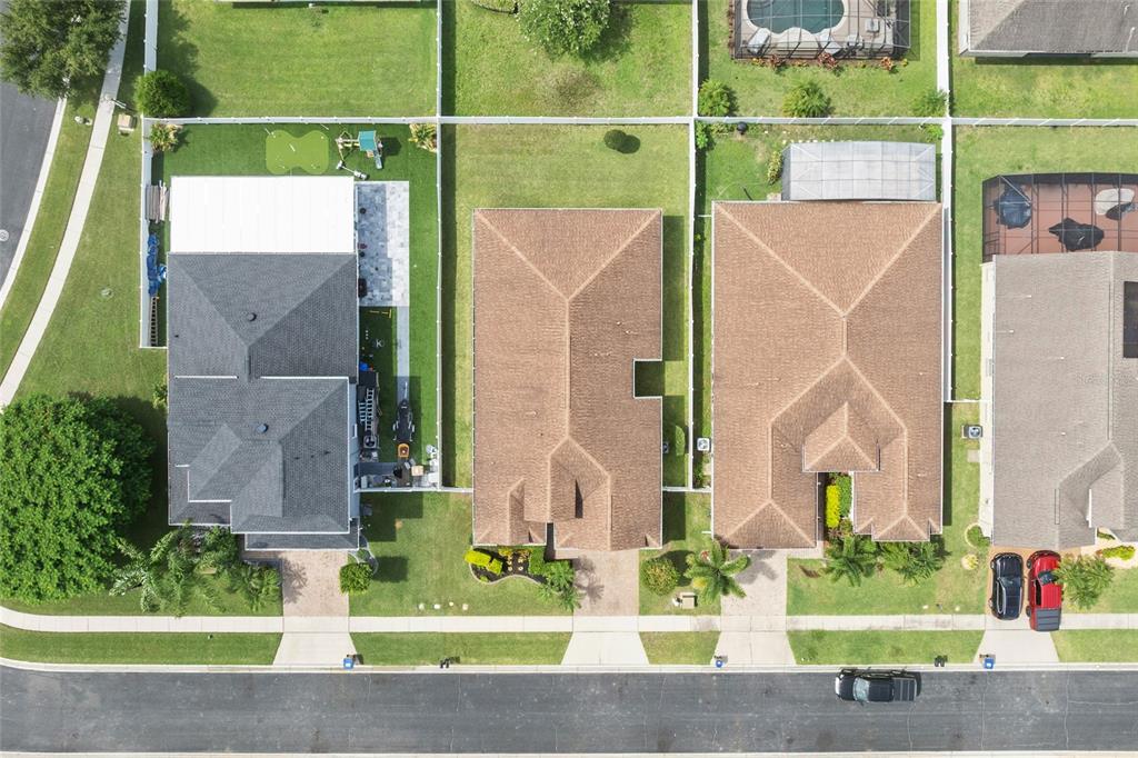 4436 Azure Isle Way Kissimmee, FL 34744 - Photo 32 of 35 a view of a house with a small yard and a large tree