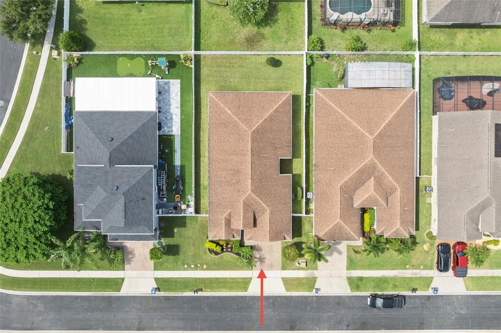 4436 Azure Isle Way Kissimmee, FL 34744 - Photo 35 of 35 a view of a house with a small yard and a large tree