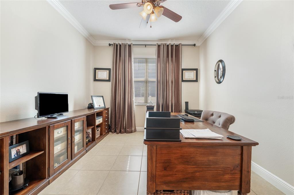 4436 Azure Isle Way Kissimmee, FL 34744 - Photo 8 of 35 a living room with furniture and a flat screen tv