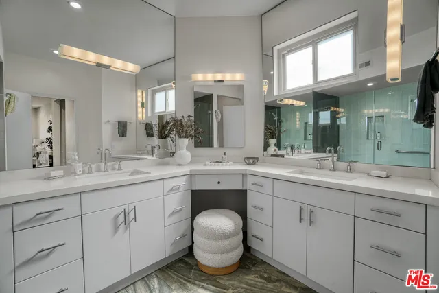 a spacious bathroom with a granite countertop sink a toilet and a mirror