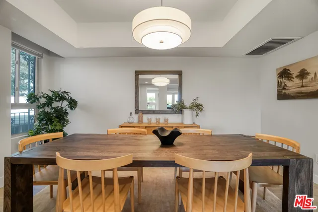 a view of a kitchen area with furniture and wooden floor
