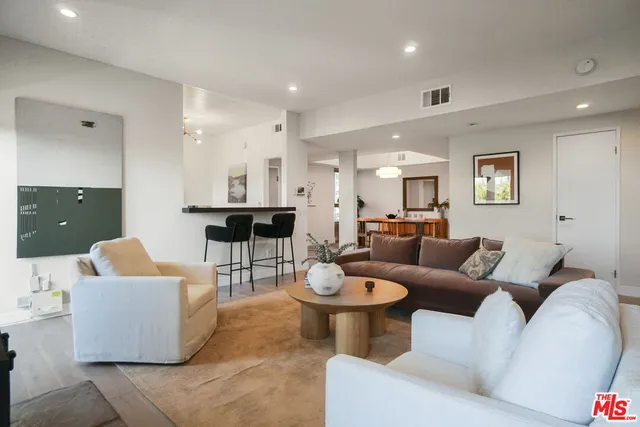 a living room with fireplace furniture and a fireplace