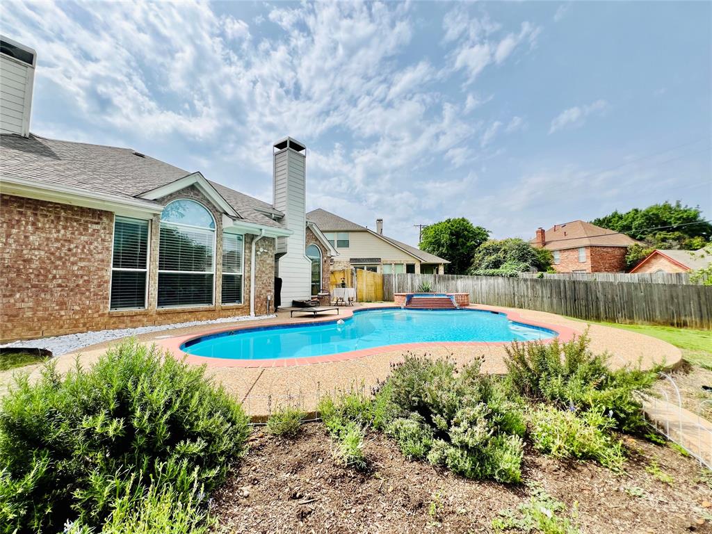 a view of a house with swimming pool and yard