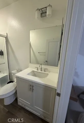 a bathroom with a sink a toilet a mirror and tub