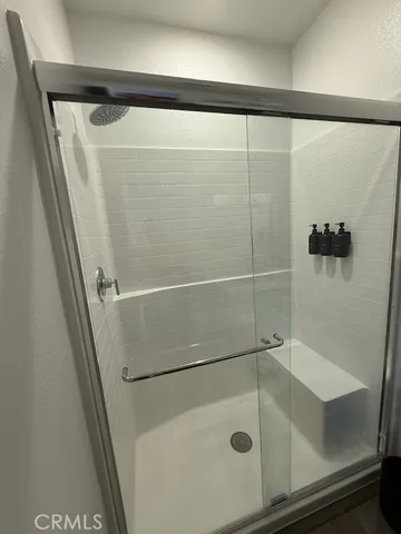 a bathroom with a shower and a sink