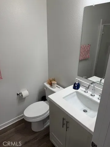 a white toilet sitting next to a bathroom sink