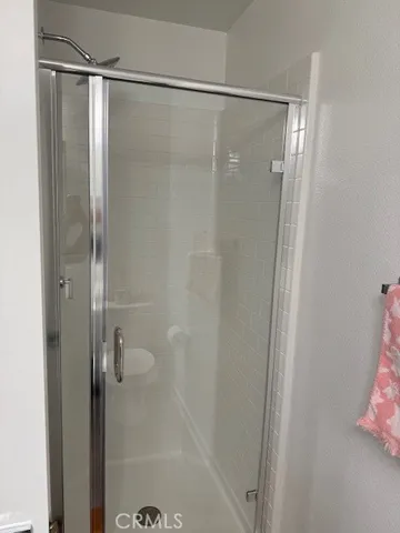 a bathroom with a glass shower door
