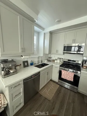 a kitchen with a sink appliances and cabinets