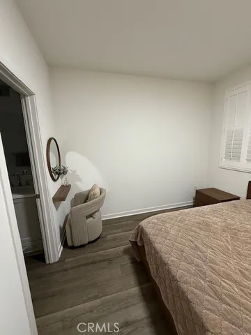a bedroom with a bed and a sink
