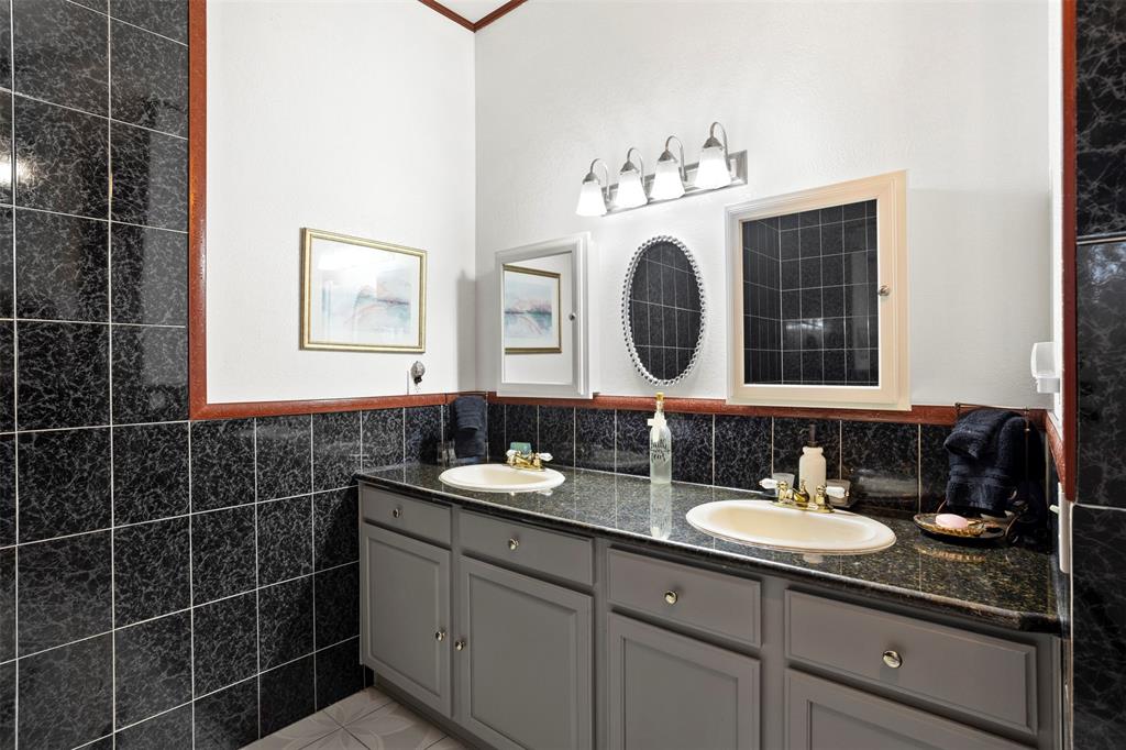 6524 Fair Road Kaufman, TX 75142 - Photo 18 of 30 a bathroom with a sink vanity and a mirror