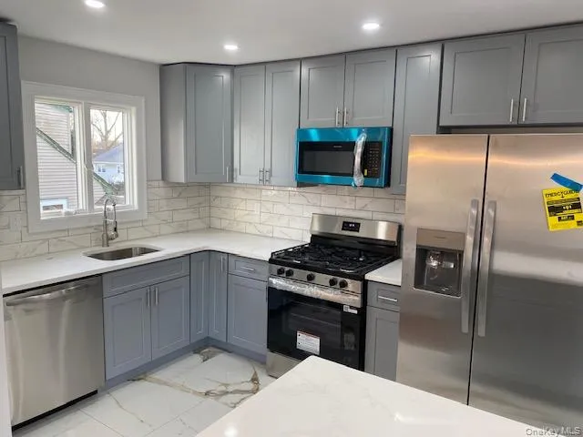 a kitchen with a sink stove and refrigerator