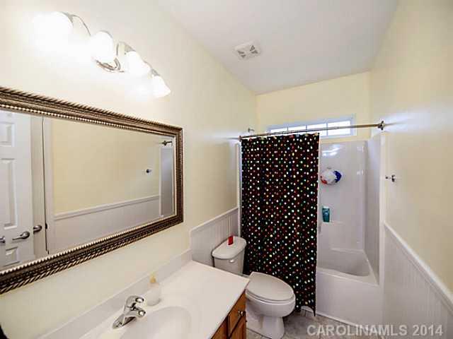 4920 Missi Lane Fort Mill, SC 29708 - Photo 13 of 16 a bathroom with a sink a toilet a mirror and shower