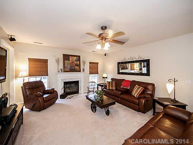 4920 Missi Lane Fort Mill, SC 29708 - Photo 3 of 16 a living room with furniture a fireplace and a flat screen tv