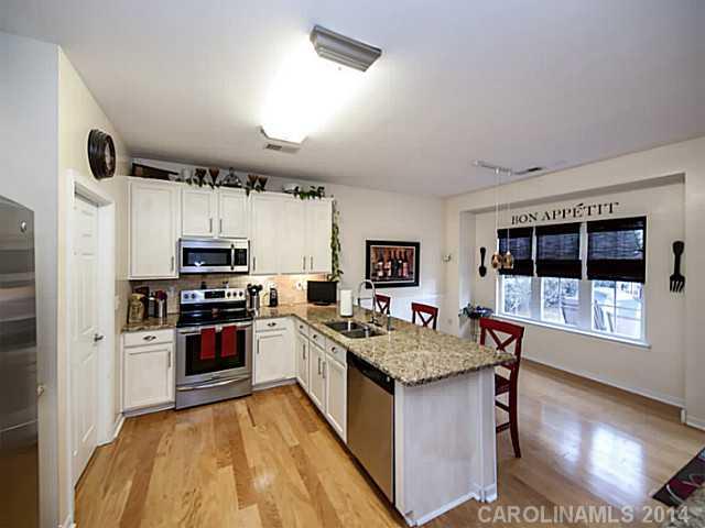 4920 Missi Lane Fort Mill, SC 29708 - Photo 7 of 16 a kitchen with stainless steel appliances granite countertop a stove top oven a sink a counter space and cabinets