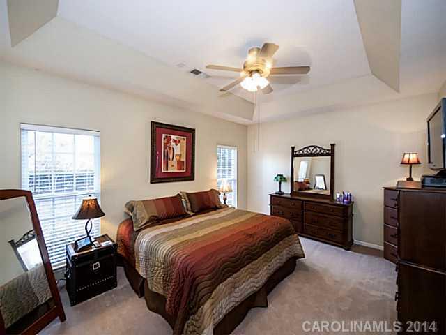 4920 Missi Lane Fort Mill, SC 29708 - Photo 8 of 16 a bedroom with a bed and wooden floor