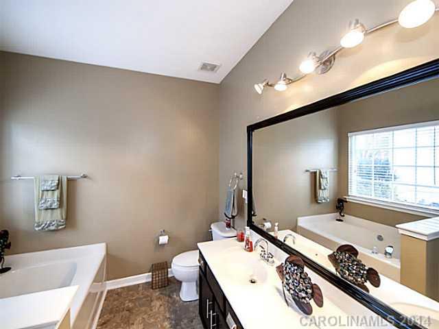 4920 Missi Lane Fort Mill, SC 29708 - Photo 9 of 16 a bathroom with a tub a sink and mirror