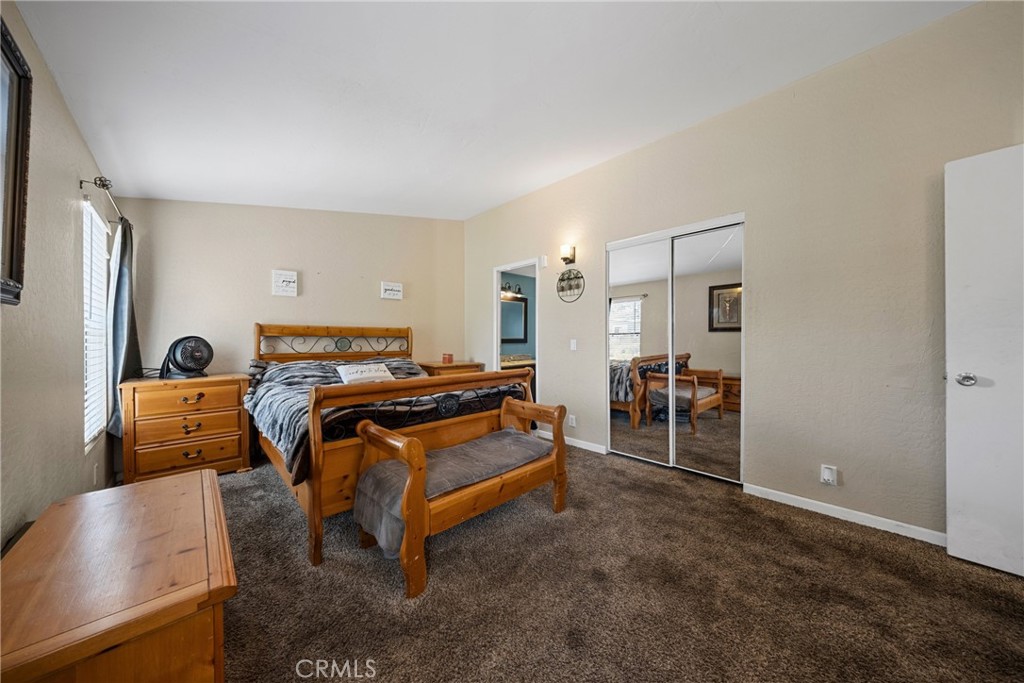 34437 Tree Lane Wildomar, CA 92595 - Photo 17 of 42 a bedroom with furniture and a flat screen tv