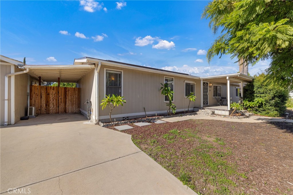 34437 Tree Lane Wildomar, CA 92595 - Photo 38 of 42 a view of a house with potted plants in front of door