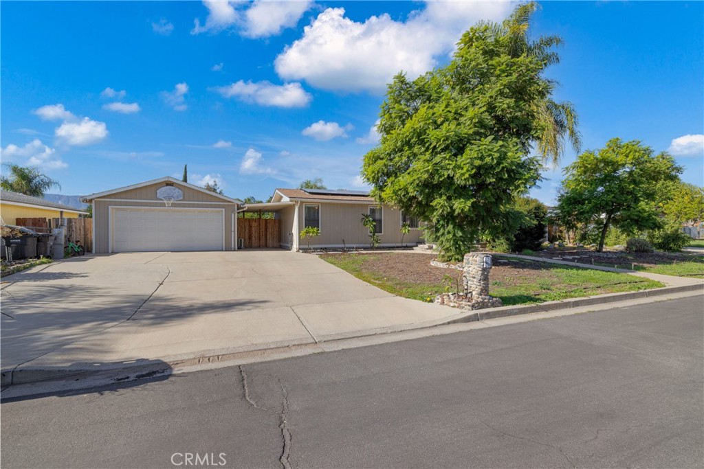 34437 Tree Lane Wildomar, CA 92595 - Photo 39 of 42 a view of house with a yard and potted plants