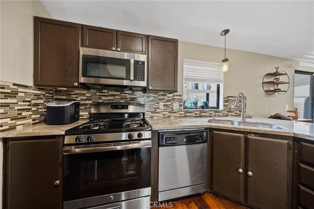 34437 Tree Lane Wildomar, CA 92595 - Photo 9 of 42 a kitchen with a sink stove and microwave