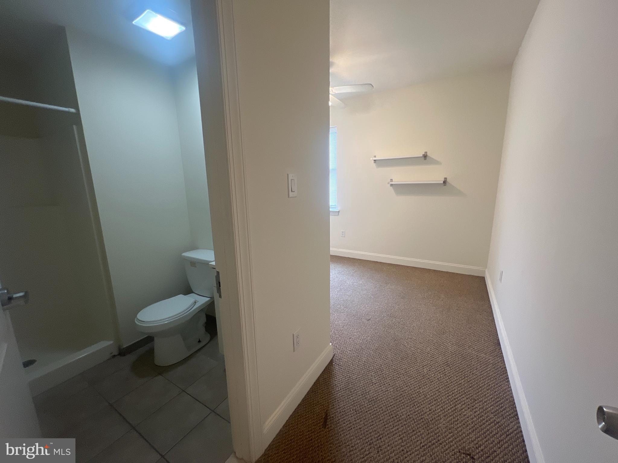 1930 North 17th Street, Unit B Philadelphia, PA 19121 - Photo 4 of 7 a bathroom with a granite countertop toilet and a sink