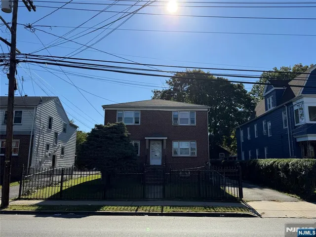 a view of a house with a street