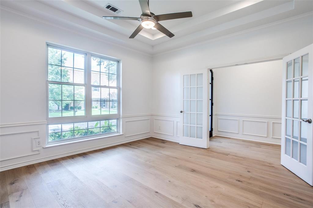 6926 Northwood Road Dallas, TX 75225 - Photo 6 of 29 an empty room with wooden floor fan and windows