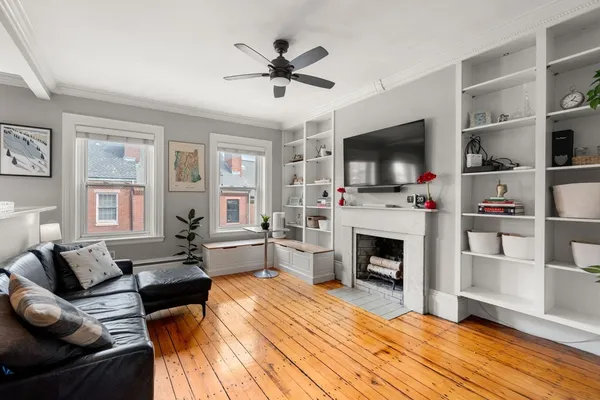 a living room with furniture a fireplace and a flat screen tv