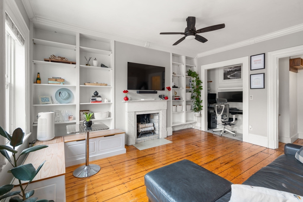 18 Harvard Street, Unit 3 Boston, MA 02129 - Photo 3 of 15 a living room with furniture fireplace and flat screen tv