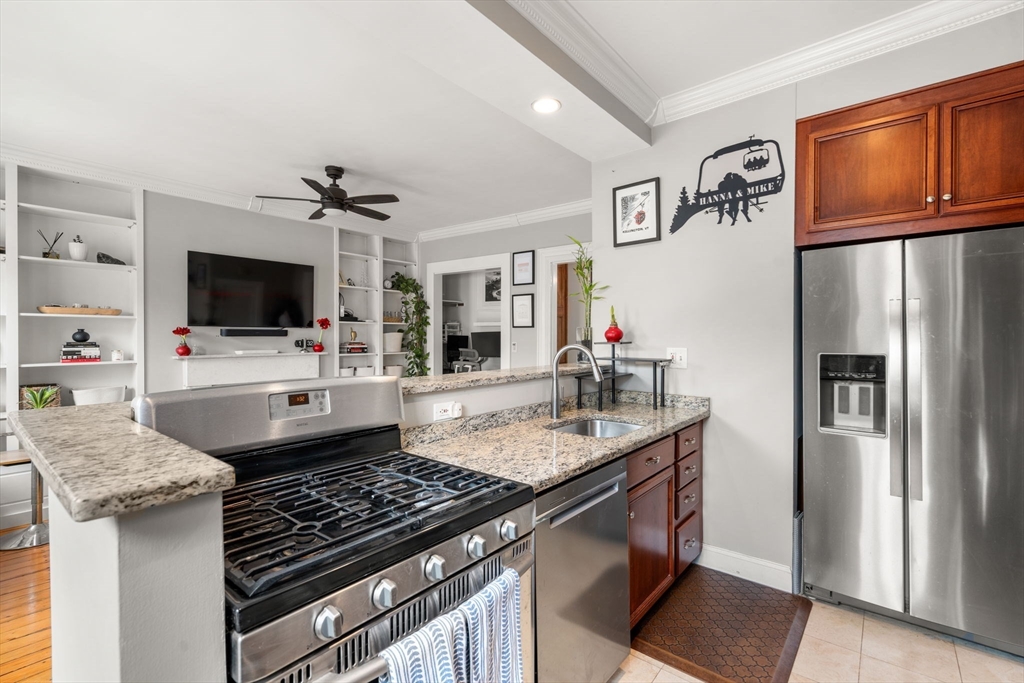 18 Harvard Street, Unit 3 Boston, MA 02129 - Photo 5 of 15 a kitchen with stainless steel appliances granite countertop a sink stove and refrigerator