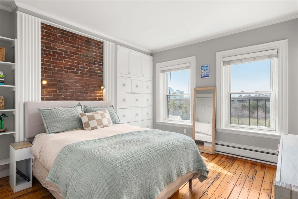 18 Harvard Street, Unit 3 Boston, MA 02129 - Photo 8 of 15 a spacious bedroom with a large bed and a large window