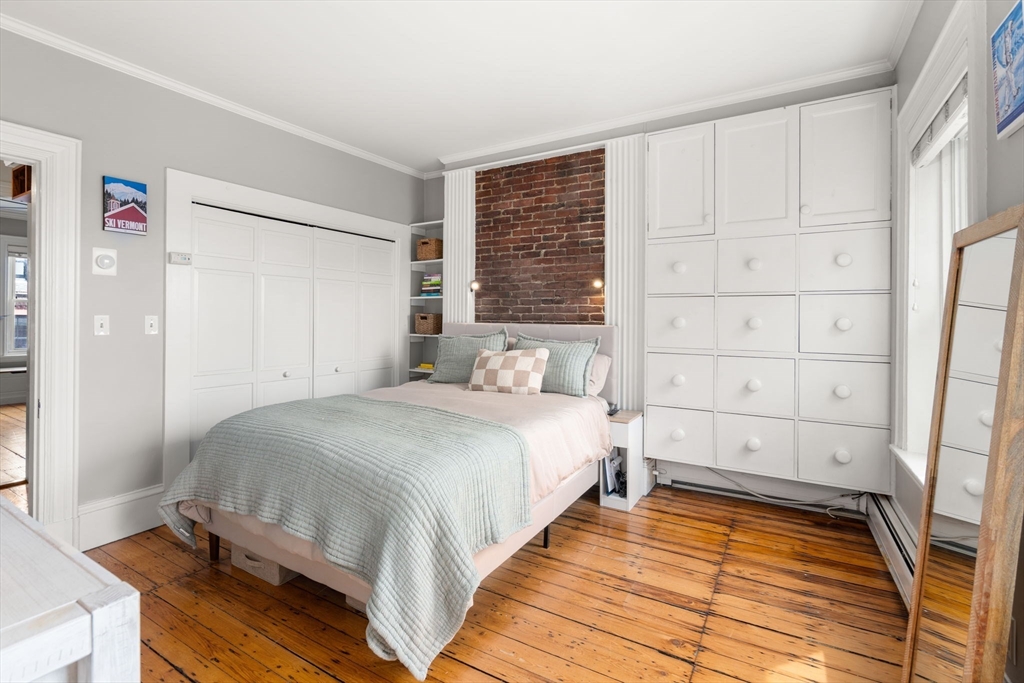 18 Harvard Street, Unit 3 Boston, MA 02129 - Photo 9 of 15 a bedroom with a bed and a window