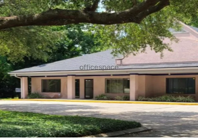 a front view of a house with a yard and potted plants