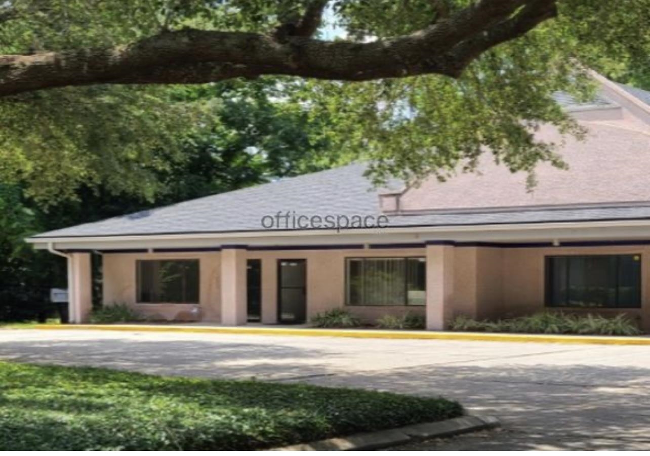 a front view of a house with a yard and potted plants