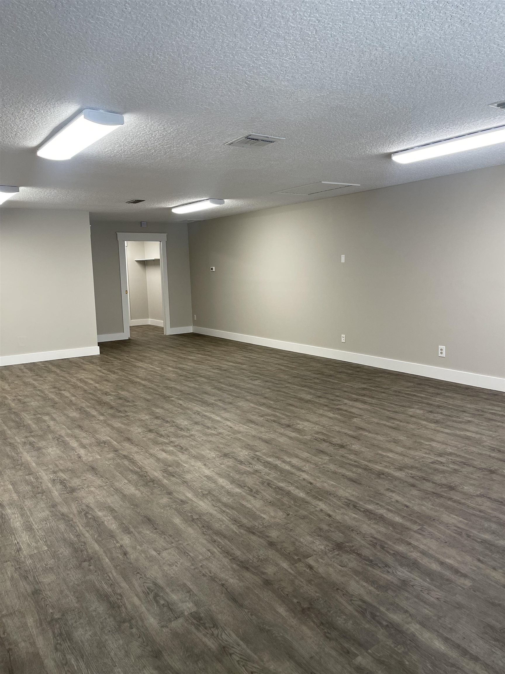 4475 Highway 1, Unit 406 St. Augustine, FL 32086 - Photo 4 of 9 an empty room with wooden floor and windows