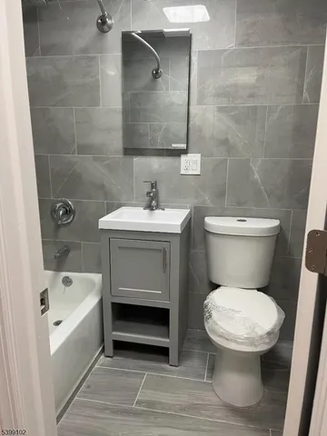 a bathroom with a toilet a sink and bathtub