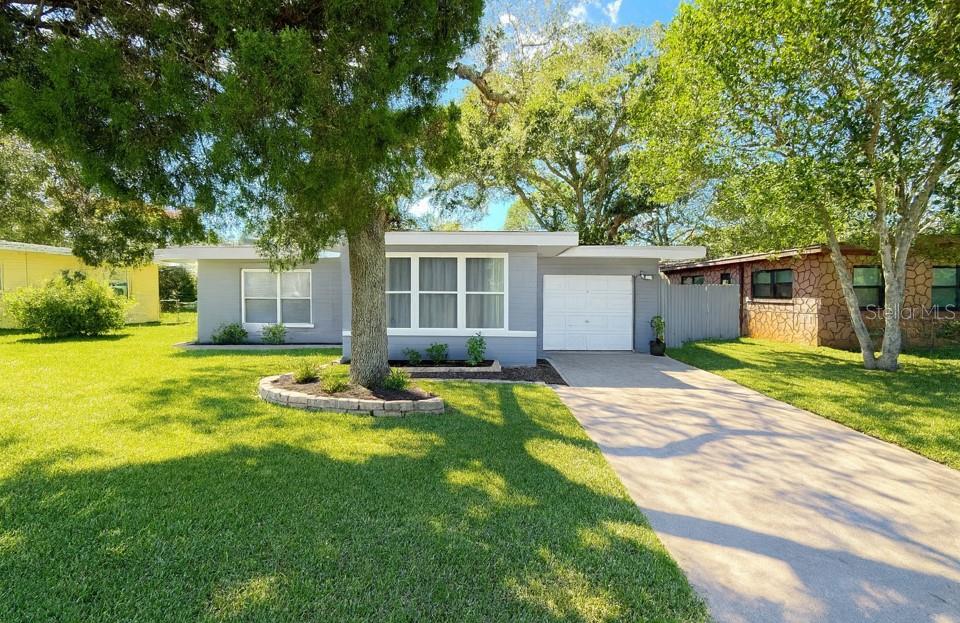 a view of a house with swimming pool and a yard