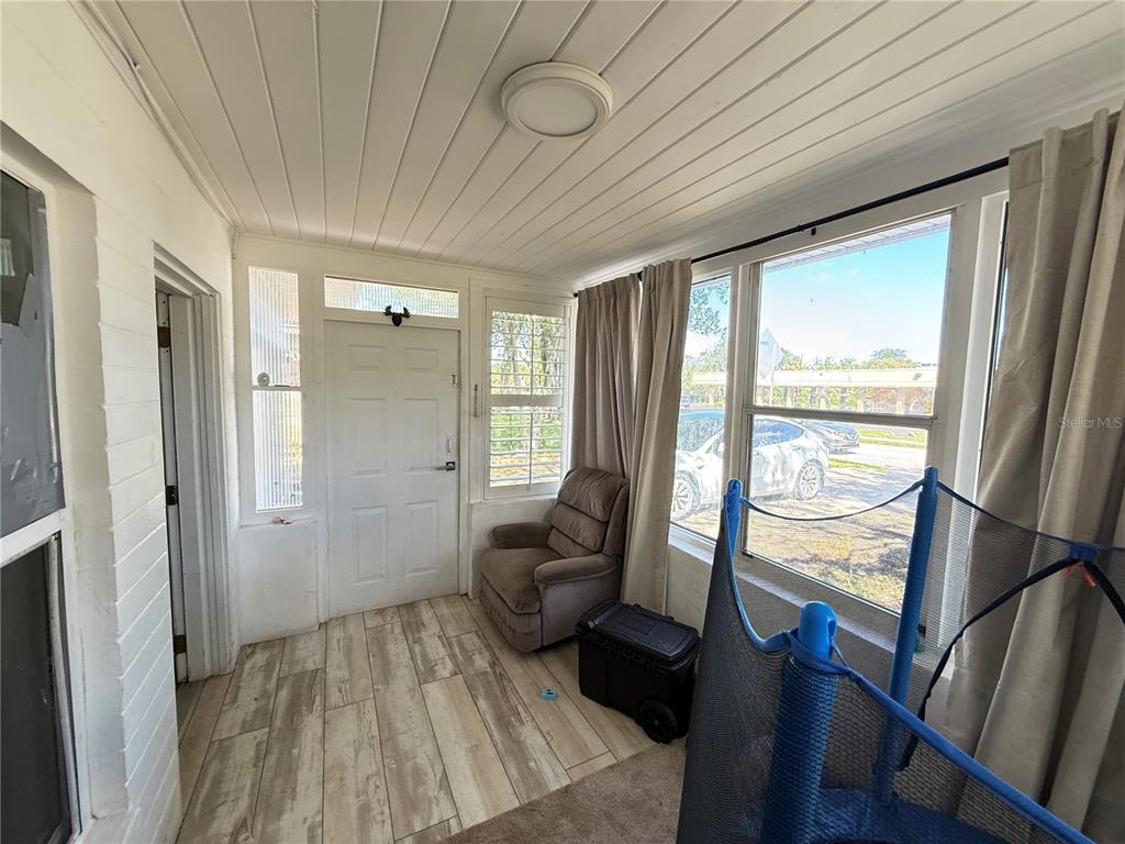 808 Derbyshire Road Daytona Beach, FL 32117 - Photo 13 of 23 a living room with furniture and a large window