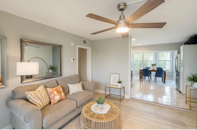 a living room with furniture and a chandelier