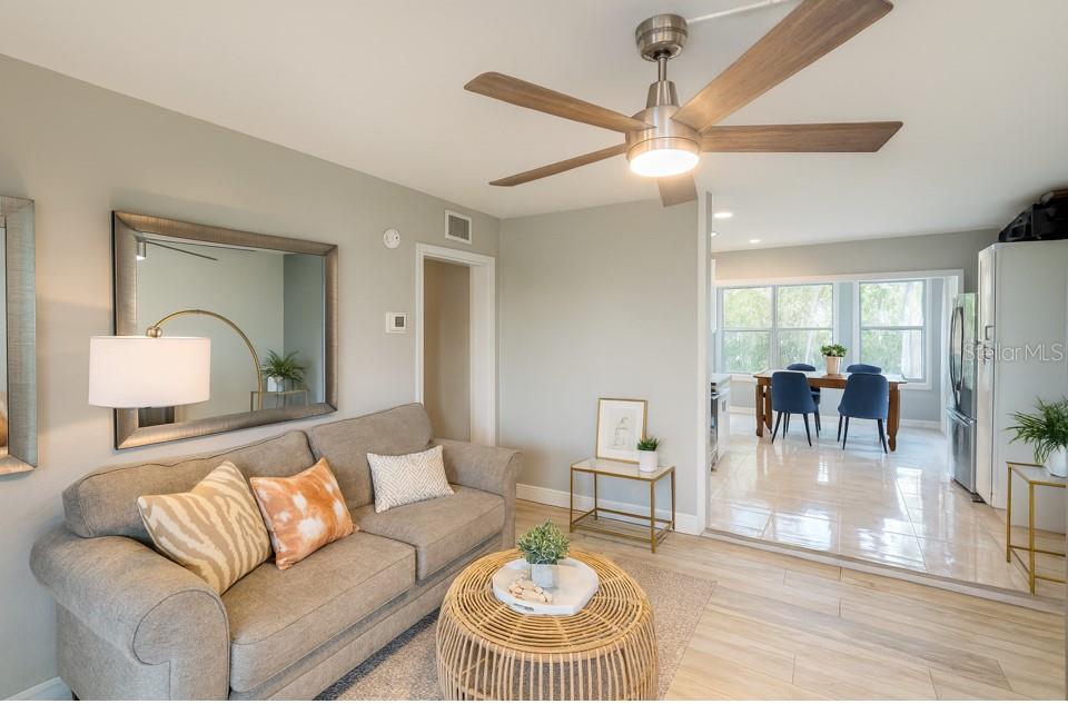 808 Derbyshire Road Daytona Beach, FL 32117 - Photo 2 of 23 a living room with furniture and a chandelier