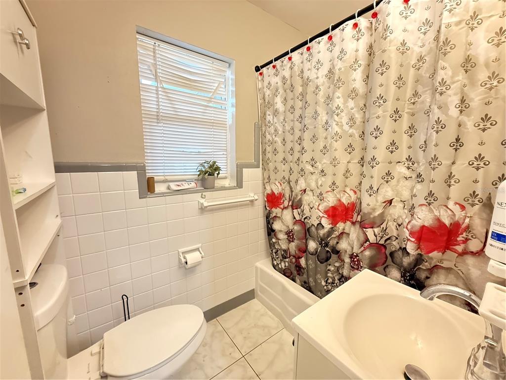 808 Derbyshire Road Daytona Beach, FL 32117 - Photo 23 of 23 a bathroom with a sink toilet and shower