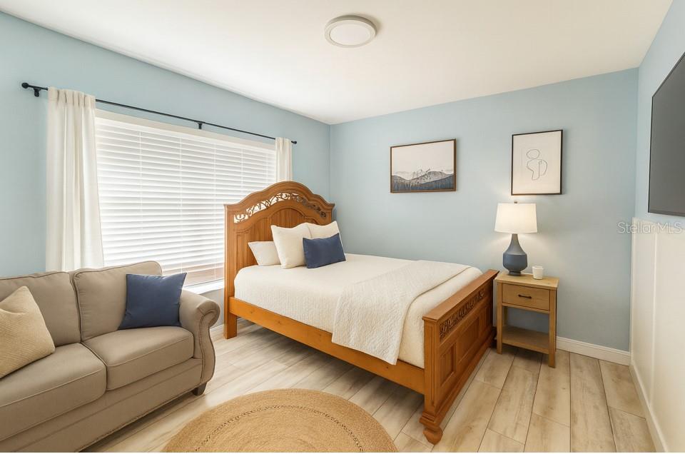 808 Derbyshire Road Daytona Beach, FL 32117 - Photo 3 of 23 a bedroom with a bed couch and window