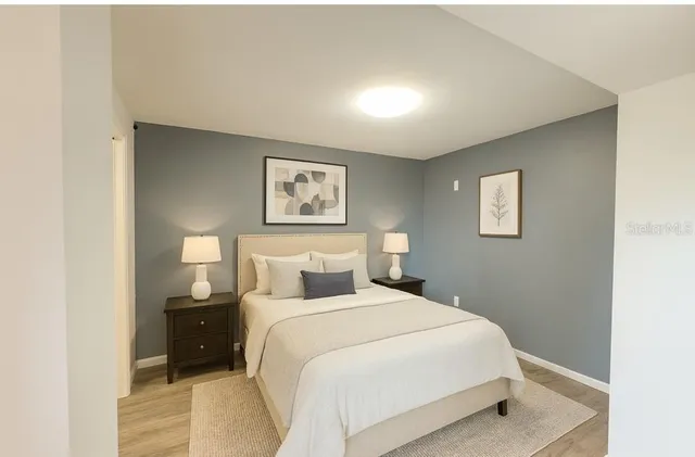 a bedroom with a bed and a night stand