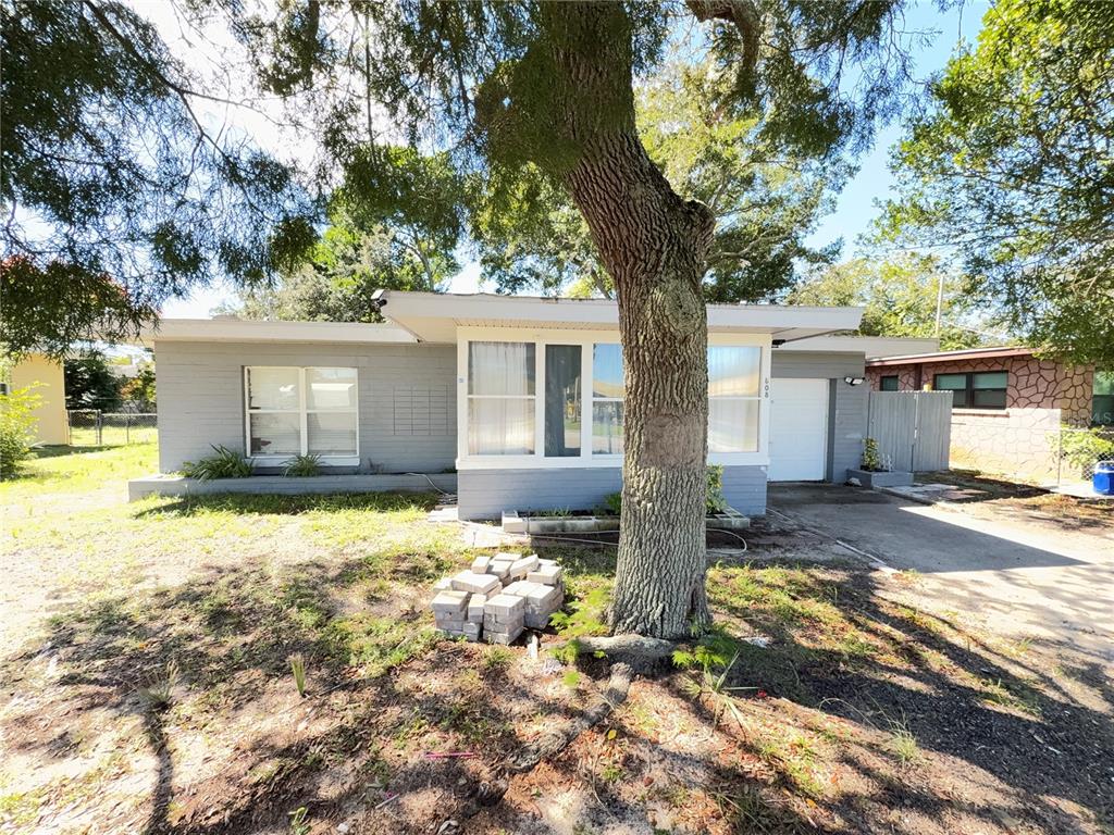 808 Derbyshire Road Daytona Beach, FL 32117 - Photo 8 of 23 a front view of a house with a yard and garage