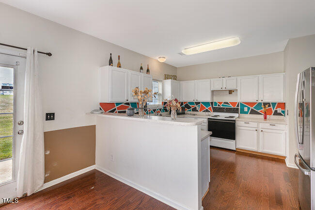 508 Summer Breeze Drive Durham, NC 27704 - Photo 11 of 28 a kitchen with refrigerator cabinets and wooden floor