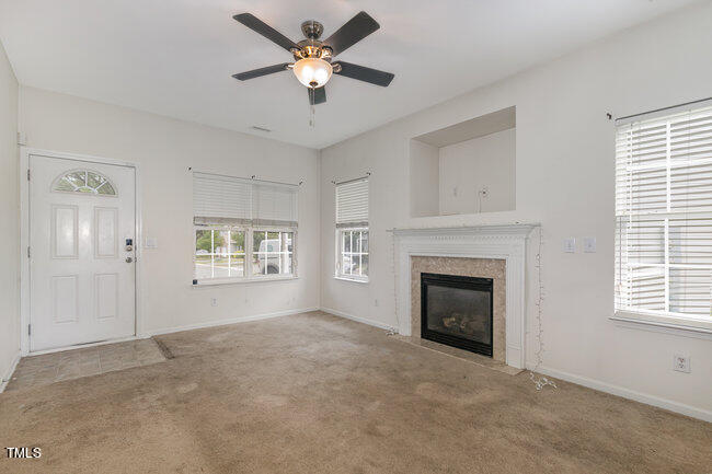 508 Summer Breeze Drive Durham, NC 27704 - Photo 4 of 28 an empty room with windows and fireplace